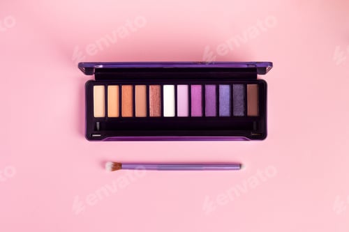 Preview: Colorful eye shadow palette and brush on pink background