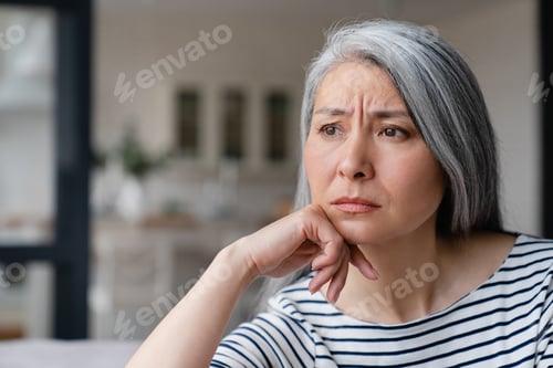Preview: Cropped front view portrait of a middle-aged woman suffering from midlife crisis