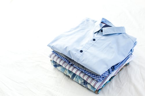 Preview: close up of ironed and folded shirts on table at home