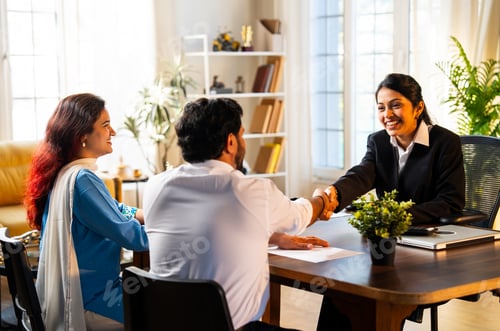 Preview: Shaking hands and showing thumbs up to camera, Indian professional executive meeting couple