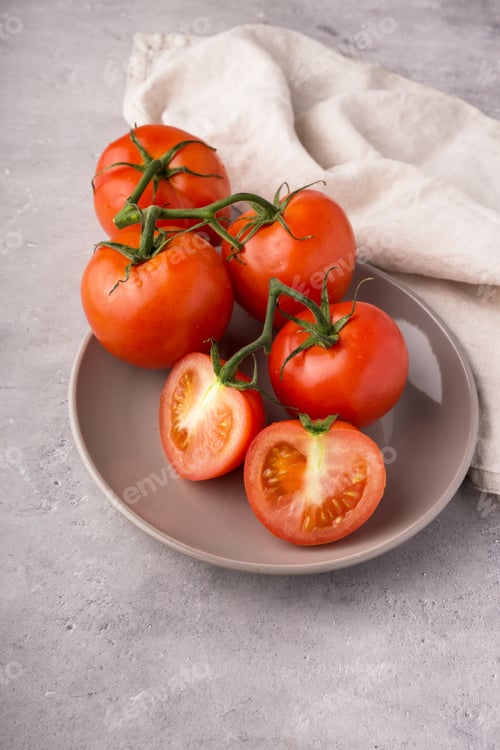 Preview: Red tomatoes on a branch on a gray background minimalism