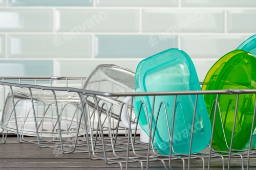 Preview: Dish rack with clean dry dishes on kitchen counter