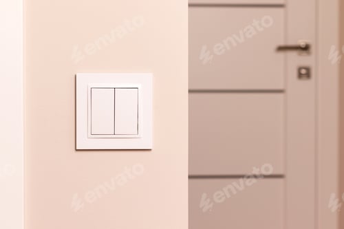 Preview: White electrical switch on beige wall