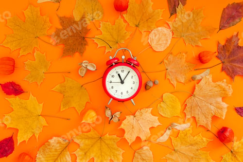 Preview: Autumn postcard with fall leaves and alarm clock