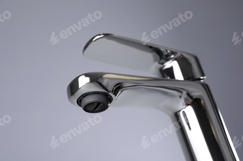 Preview: Single handle water tap on grey background, closeup