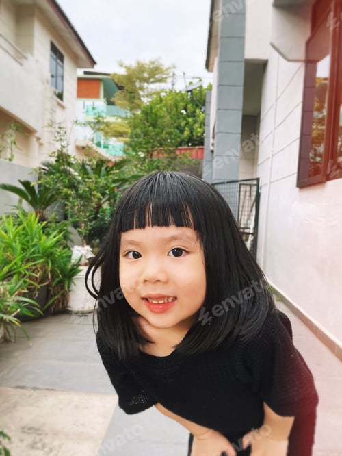 Preview: Little girl doing yoga in the garden