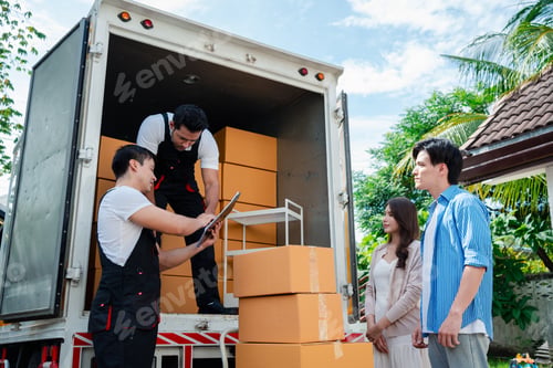 Preview: Asian Couple check while unloading boxes and furniture from a pickup truck