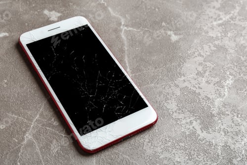 Preview: Modern smartphone with broken display on table, space for text. Device repair service