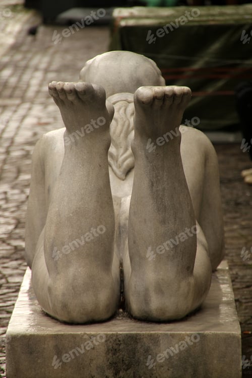 Preview: two feet on top of the statue's feet sitting on top of bricks
