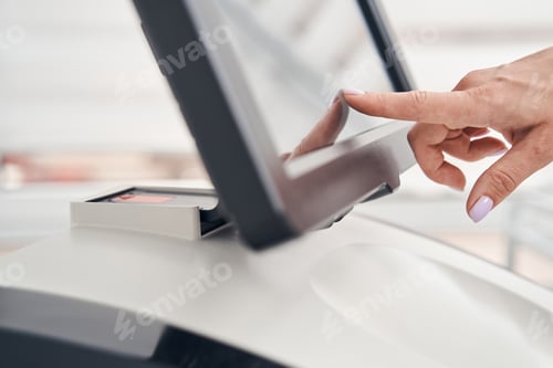 Preview: Female cosmetologist using modern electronic machine indoors