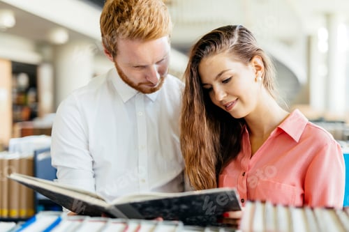 Preview: Two students reading and studying in library