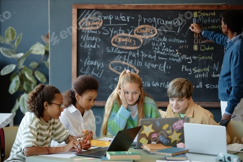 Preview: Group of Puzzled Kids Working in Class Using Computers