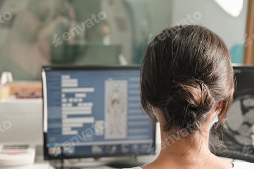 Preview: woman radiologist looking at monitor with an x-ray image. examining and diagnostics