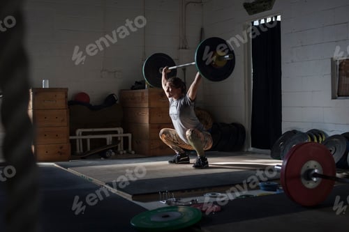 Preview: Woman lifting barbell in gym