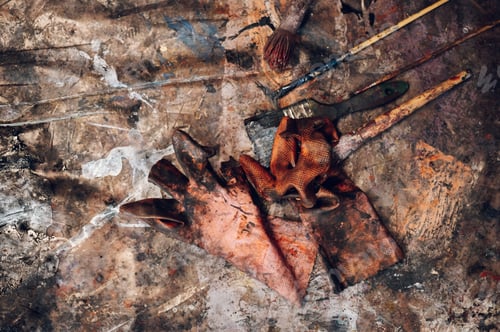Preview: Dirty paintbrushes laying on the floor of an artist studio