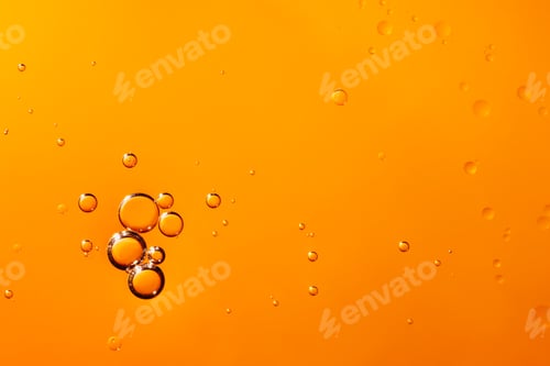 Preview: oil with bubbles on orange background. Abstract space background.