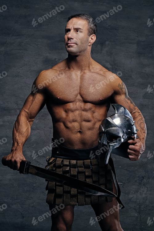 Preview: Middle age, muscular male holds silver gladiator helmet and an i