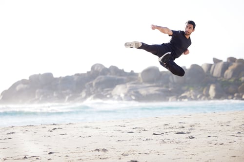 Preview: Full length shot of a handsome young male athlete working out on the beach