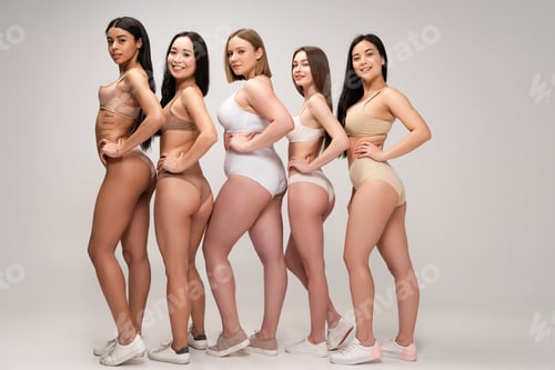 Preview: five young multiethnic women in lingerie posing with hands on hips, body positivity concept