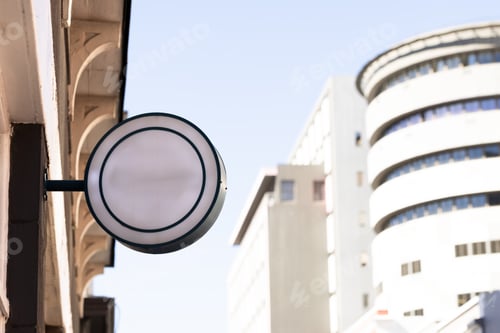 Preview: Blank round sign fixed to building wall with copy space
