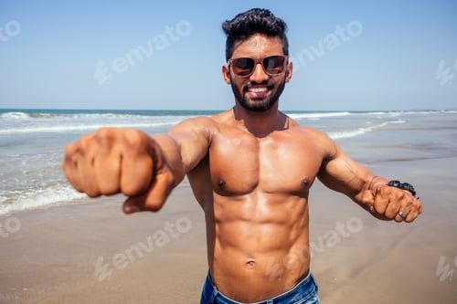 Preview: portrait of happy young african man on the beach.
