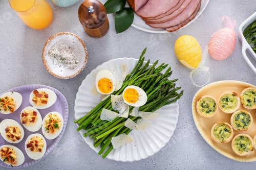 Preview: Cooked asparagus served with shaved parmesan and eggs for Easter brunch