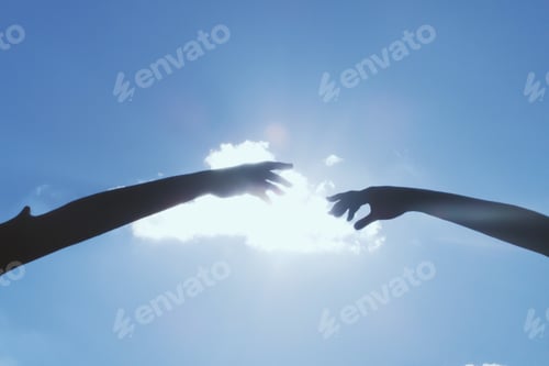 Preview: Two silhouetted hands in frame reaching towards each other with a blue sky sunny cloud background