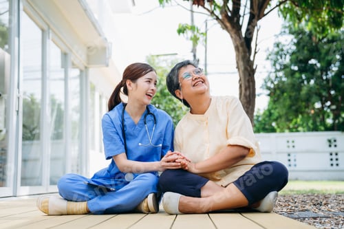 Preview: Female Nurse Providing Homecare and Healthcare Support to Senior Woman in Home Garden.