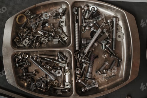 Preview: Silver cassette with screws and bolts in the garage