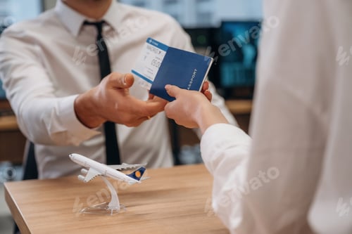 Preview: Woman is giving boarding pass, tickets to airline company worker