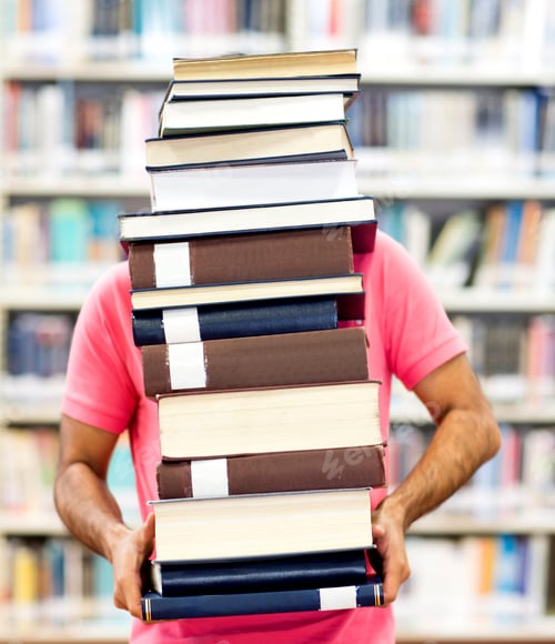 Preview: Male Student Carrying Heavy Books At The Library