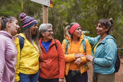 Preview: Group of multi generational women having fun during hiking day in the forest