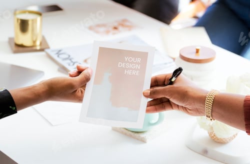Preview: Woman handing a paper mockup in the meeting room
