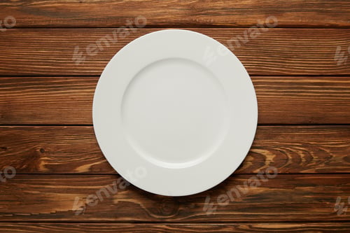 Preview: top view of white empty plate on wooden background