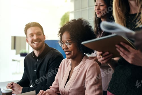 Preview: Smiling group of diverse businesspeople working together in an office