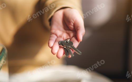 Preview: Closeup image of a woman holding the keys for real estate concept