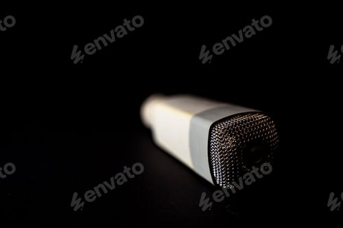 Preview: Selective focus of a microphone on black background