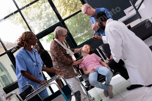 Preview: Little girl faints and collapses on the chair in hospital reception during medical examination