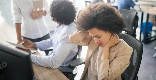 Preview: Young african business woman having stress and headache in the office