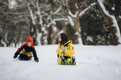 Preview: Children playing in snow-covered winter park