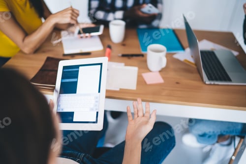 Preview: Crop colleagues working on project in office