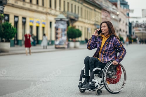 Preview: Woman with disability using a smartphone while out in the city