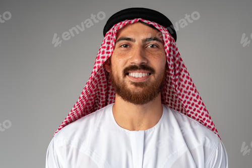 Preview: Portrait of smiling young Arab man on gray background