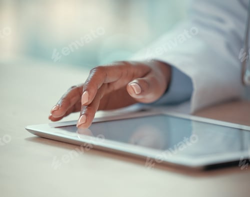 Preview: Closeup on fingers of doctor working on a digital tablet. Medical doctor using an online app on a w