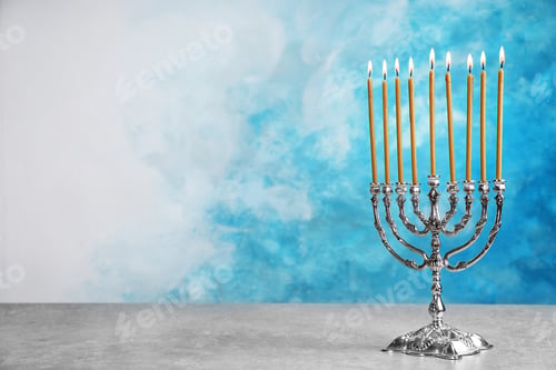 Preview: Hanukkah menorah on table against color background