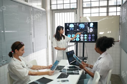 Preview: Group of doctors looking at X-ray on medical conference, discussing issues