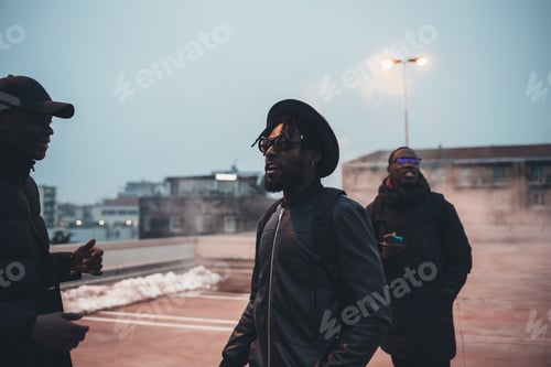 Preview: three young african men walking in the street and speaking