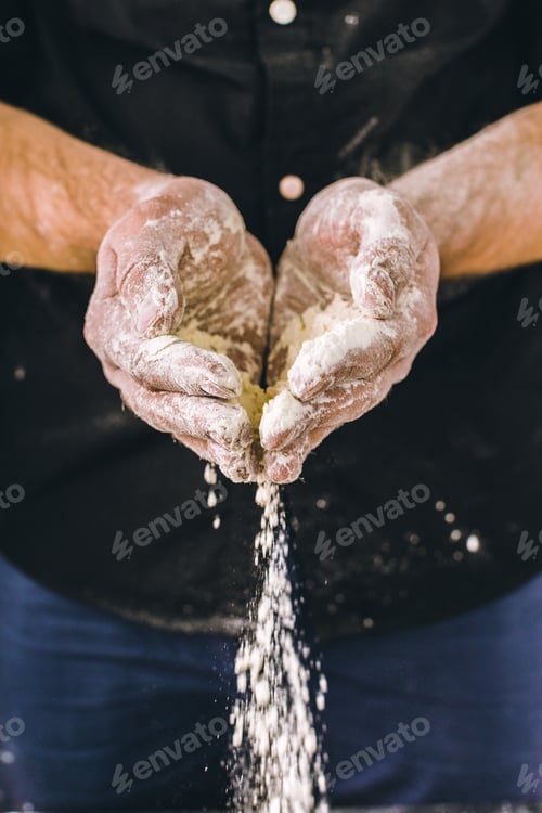 Preview: adult man hands work with flour, dark photo