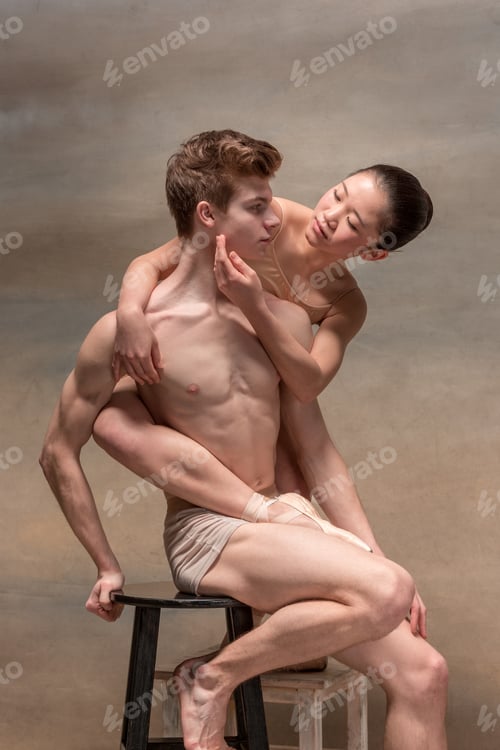 Preview: Couple of ballet dancers posing over gray background
