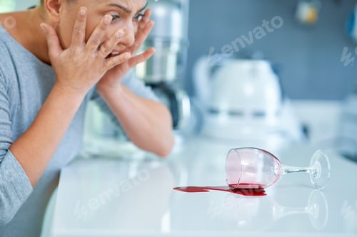 Preview: Young woman and spilled wine in the kitchen